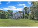 Spacious backyard featuring a well-manicured lawn and mature trees, offering a serene outdoor setting at 118 N 7Th St, Smithfield, NC 27577