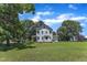 Expansive backyard view showing the house and lush greenery, perfect for outdoor activities at 118 N 7Th St, Smithfield, NC 27577