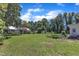 Spacious backyard featuring lush green lawn, mature trees, and a patio area, ideal for outdoor activities and relaxation at 118 N 7Th St, Smithfield, NC 27577