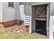 Exterior view of a basement entrance with a wooden door and brick foundation, providing convenient access to the lower level at 118 N 7Th St, Smithfield, NC 27577