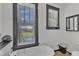 A bright bathroom with black window trim features a claw foot tub and natural light at 118 N 7Th St, Smithfield, NC 27577
