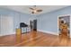Spacious bedroom with light blue walls, wood floors, and a ceiling fan at 118 N 7Th St, Smithfield, NC 27577