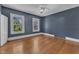 This bedroom has hardwood floors, two bright windows and a ceiling fan at 118 N 7Th St, Smithfield, NC 27577