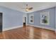 Light blue bedroom with hardwood floors, two windows, and a ceiling fan at 118 N 7Th St, Smithfield, NC 27577