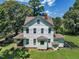 Exterior view of the home, with a manicured lawn and view of the garden plot at 118 N 7Th St, Smithfield, NC 27577