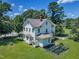 Exterior view of the home, surrounded by lush greenery, showing backyard plot at 118 N 7Th St, Smithfield, NC 27577