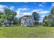 Exterior backyard view showcasing lush green lawn, mature trees and white siding at 118 N 7Th St, Smithfield, NC 27577