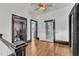 Hallway with hardwood floors and dark trim that leads to a bedroom and bathroom at 118 N 7Th St, Smithfield, NC 27577