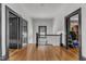 A bright hallway with black trim, wood floors, and windows at 118 N 7Th St, Smithfield, NC 27577