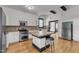 Bright kitchen showcases white cabinets, stainless appliances, and a kitchen island with bar stool seating at 118 N 7Th St, Smithfield, NC 27577