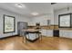 Traditional kitchen features white cabinets, an island with seating, and modern stainless steel appliances at 118 N 7Th St, Smithfield, NC 27577