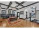 Spacious living room featuring hardwood floors, coffered ceilings, and a cozy fireplace at 118 N 7Th St, Smithfield, NC 27577