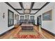 Bright living room boasts hardwood floors, fireplace, coffered ceilings and elegant chandelier at 118 N 7Th St, Smithfield, NC 27577