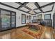 Inviting living room with fireplace, decorative ceiling, hardwood floors, and ample natural light at 118 N 7Th St, Smithfield, NC 27577