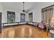 Bright living room boasts hardwood floors, ceiling fan, and three large windows, creating a welcoming atmosphere at 118 N 7Th St, Smithfield, NC 27577