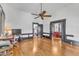Spacious living room features hardwood floors, a ceiling fan, and easy access to other rooms in the home at 118 N 7Th St, Smithfield, NC 27577