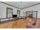 Spacious living room features beautiful hardwood floors, ample natural light, and a chandelier at 118 N 7Th St, Smithfield, NC 27577