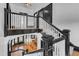 Overhead view of a staircase with dark wood trim, white railings, and chandelier below at 118 N 7Th St, Smithfield, NC 27577