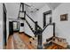 Elegant staircase with dark wood trim, white railings, and a stunning chandelier overhead at 118 N 7Th St, Smithfield, NC 27577