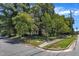 A serene home partially obscured by trees, along a quiet neighborhood street, offering a peaceful and private living environment at 118 N 7Th St, Smithfield, NC 27577