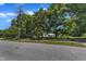 A serene home partially obscured by trees, along a quiet neighborhood street, offering a peaceful and private living environment at 118 N 7Th St, Smithfield, NC 27577