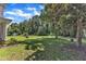 Expansive yard featuring mature trees, a lush green lawn, and partial views of the home's exterior, creating a serene setting at 118 N 7Th St, Smithfield, NC 27577