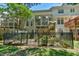 Exterior view of the home's back featuring a porch and an iron fence surrounding a garden at 119 Jones Creek Place Pl # 119, Chapel Hill, NC 27516