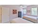 Inviting bedroom with two twin beds, a dark dresser, and plenty of natural light from the windows at 119 Jones Creek Place Pl # 119, Chapel Hill, NC 27516