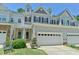 Charming townhome with two-car garage, manicured lawn, and classic architectural details at 119 Jones Creek Place Pl # 119, Chapel Hill, NC 27516