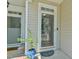 Close-up view of the home's main entrance with a glass storm door and sidelight window at 119 Jones Creek Place Pl # 119, Chapel Hill, NC 27516