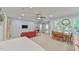 Open-concept living room with a red sofa, dining table, and doors leading to the outside at 119 Jones Creek Place Pl # 119, Chapel Hill, NC 27516