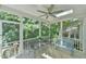 Cozy screened porch with seating, a ceiling fan, and views of the surrounding lush greenery at 119 Jones Creek Place Pl # 119, Chapel Hill, NC 27516