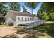 Exterior view of a home featuring a large white deck with ramp access, surrounded by trees at 119 Percheron Dr, Zebulon, NC 27597
