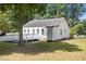 Rear exterior view of the home featuring a white deck with wheelchair access, and a lush green lawn at 119 Percheron Dr, Zebulon, NC 27597