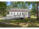 Home exterior featuring a deck with ramp, surrounded by a lawn and mature trees in the backyard at 119 Percheron Dr, Zebulon, NC 27597