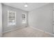 Cozy bedroom with two bright windows and neutral carpet at 119 Percheron Dr, Zebulon, NC 27597