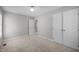A carpeted bedroom offers ample closet space and a doorway, perfect for relaxation at 119 Percheron Dr, Zebulon, NC 27597