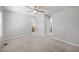 Spacious carpeted bedroom with a ceiling fan and a view into the attached bathroom at 119 Percheron Dr, Zebulon, NC 27597