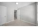 A cozy bedroom featuring neutral walls, carpeted flooring, and a bright overhead light at 119 Percheron Dr, Zebulon, NC 27597