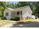 This beautiful home features white siding, a porch, and well maintained grounds at 119 Percheron Dr, Zebulon, NC 27597