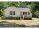 Charming one-story home featuring a cozy front porch and well-maintained landscaping at 119 Percheron Dr, Zebulon, NC 27597