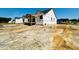 View of new home build, with covered porch and Tyvek HomeWrap at 128 Seahawk Way, Zebulon, NC 27597