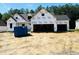 View of new construction home featuring a three-car garage and Tyvek HomeWrap at 128 Seahawk Way, Zebulon, NC 27597
