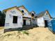 View of new construction featuring Tyvek HomeWrap, a front porch and basement windows at 128 Seahawk Way, Zebulon, NC 27597
