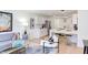 Open-concept living area with a gray sofa, modern chairs, and a glimpse into the stylish kitchen with stainless appliances at 1309 Hudson Ave # D6, Durham, NC 27705