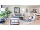 Bright living room featuring a modern sofa, stylish chairs, contemporary art, and an open layout with a view to the kitchen at 1309 Hudson Ave # D6, Durham, NC 27705
