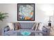 Detailed shot of a sofa with decorative pillows and a glass coffee table, set beneath a modern art piece at 1309 Hudson Ave # D6, Durham, NC 27705
