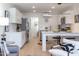Open-concept living space with kitchen bar and view into dining and living areas at 1309 Hudson Ave # D6, Durham, NC 27705