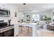 Open-concept living space with kitchen bar and view into dining and living areas at 1309 Hudson Ave # D6, Durham, NC 27705