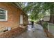 Side yard features a brick exterior, white door, and concrete walkway at 1402 Tarleton Ave, Burlington, NC 27215